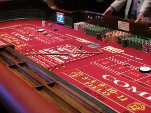 The craps table is strategically organized, featuring several distinct sections, each contributing uniquely to the game: