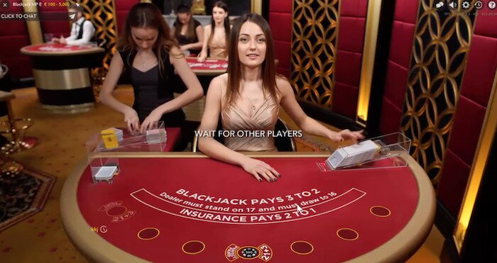 A snapshot of live dealer blackjack featuring the dealer and the gaming table.