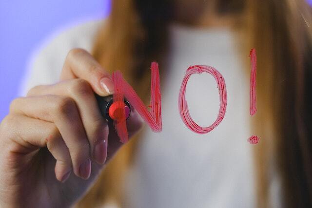 person writing no in red marker