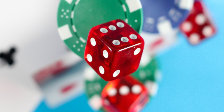 A collection of focused dice amidst a blurred array of poker chips