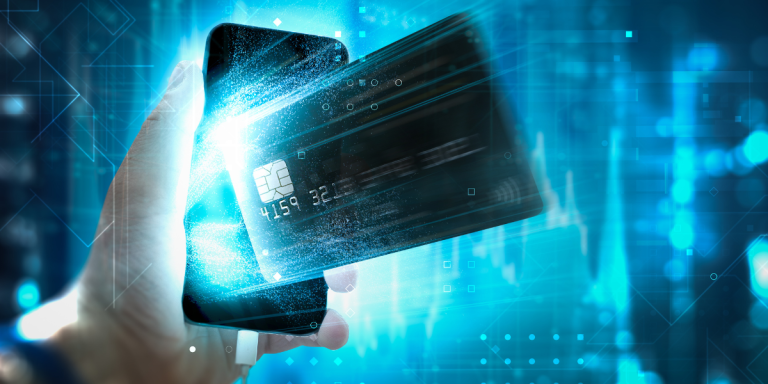 A hand emerges from a smartphone clutching a credit card, set against a high-tech backdrop