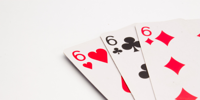 Display of three playing cards, each showing a six in a different suit.